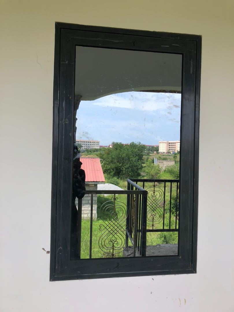 Balcony-facing window with tinted glazing in a finished home